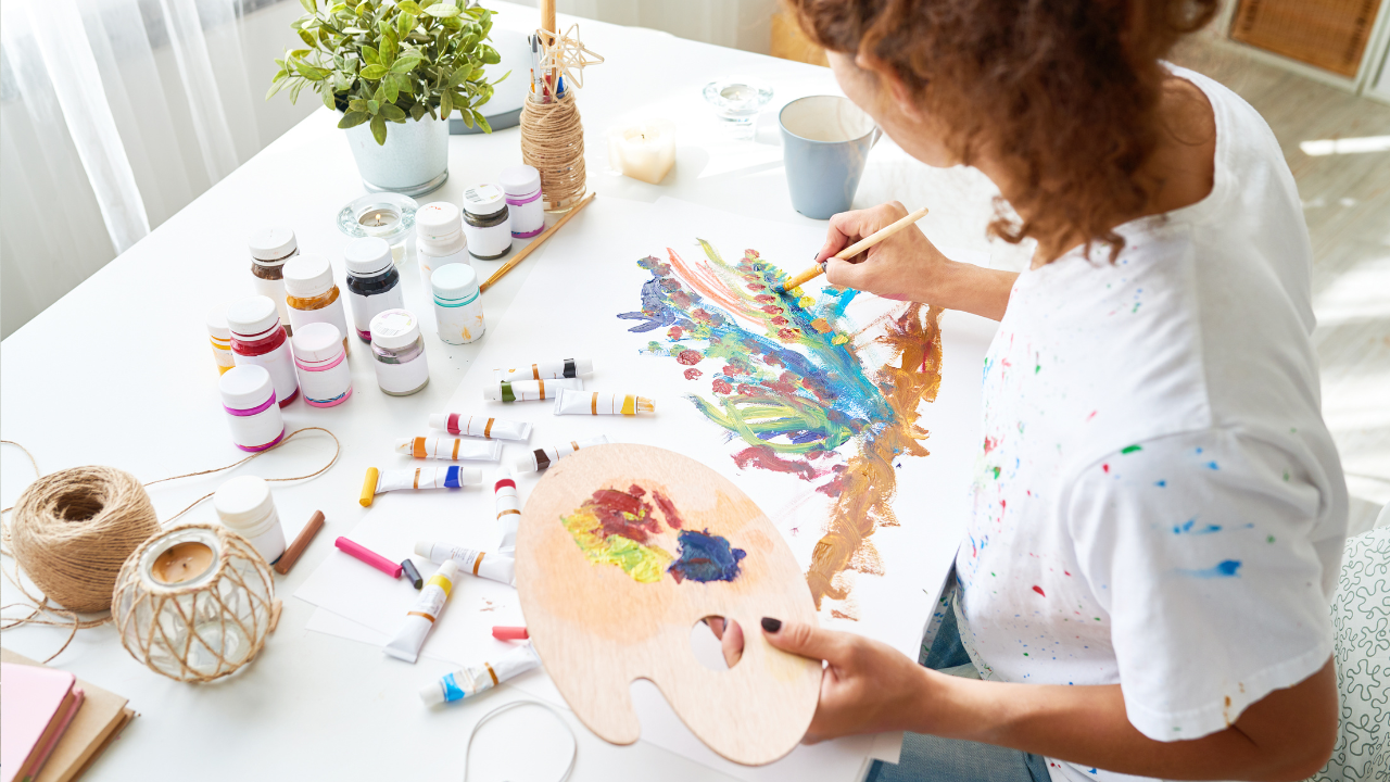 Art therapy- person wearing white t-shirt painting