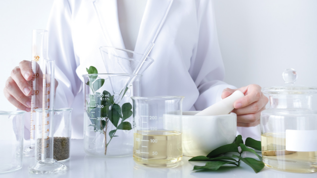 scientist with plants and vials